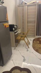 a living room with a table and a desk with a television at Rahej home in Bandar al Manşūrah