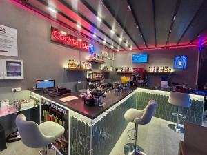 a bar in a restaurant with chairs and a counter at 7 Brothers Hotels in Marmaris