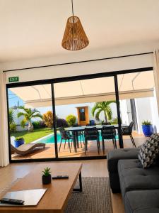 a living room with a couch and a table at Villa Marea Private Pool in Grand Baie with garden, BBQ & Parking in Grand-Baie