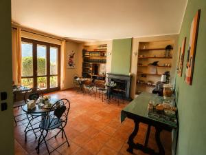 a living room with a table and chairs and a fireplace at La quercia di Massena in Lauria Inferiore