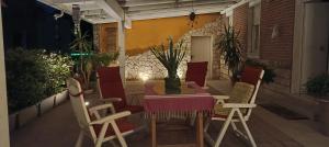 a table and chairs on a patio at night at levIole in Belfiore