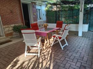 a table and chairs sitting on a patio at levIole in Belfiore +6 photos