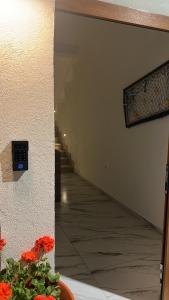 a hallway with a clock on the wall and a plant at Corte Moscara Vasto Centro in Vasto +11 photos