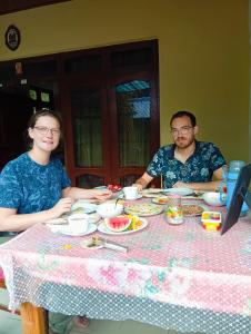 a man and a woman sitting at a table at Steur Villa in Kepungoda