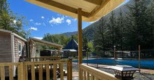 a wooden deck with a view of a swimming pool at El Chate in Sarvisé