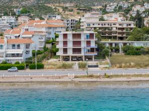 a group of houses on a hill next to the water at Porto Marina SeaView in Porto Rafti