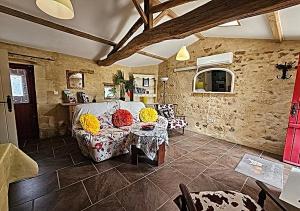 a living room with a couch and a table at Gite du Passignac in Saint-Maigrin
