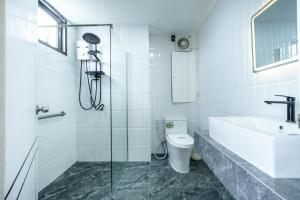 un bagno con doccia, WC e lavandino di Tittower a Bangkok