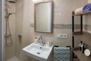 a bathroom with a sink and a shower and a mirror at Cal Folquer in Alentorn +7 photos