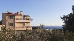 a building with a balcony on top of it at Stone House Bonaca with Sea View in Baška Voda