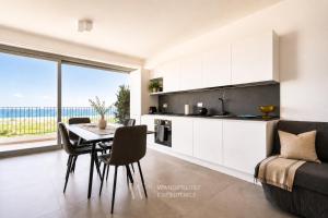 a kitchen and dining room with a table and a couch at Wanderlust Experience Costa Sud in Bari