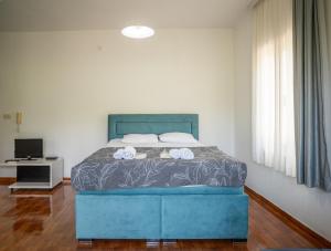 a bedroom with a blue bed with towels on it at Apartments Oasis in Budva +53 photos