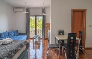 a living room with a blue couch and a table at Apartments Oasis in Budva