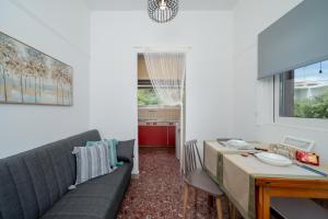 a living room with a couch and a table at Porto Marina SeaView in Porto Rafti