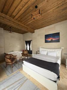 a bedroom with a large bed and a bath tub at Duruer Living Home in Ürgüp