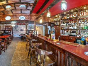 a bar with wooden bar stools in a restaurant at Tower Hotel in Oxton +20 photos