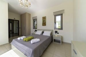 a bedroom with a large bed with towels on it at Villa Caterina in Skala +30 photos