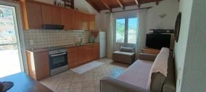 a kitchen with a stove and a refrigerator at Lambrini Studios in Parga