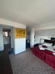 a bedroom with a bed with a red bedspread at Peshev Family Hotel Nesebar in Nesebar +82 photos