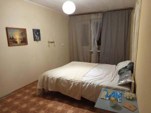 a small bedroom with a bed and a window at Квартира над Парусом in Zhmerynka +7 photos