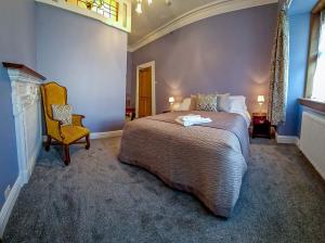a bedroom with a large bed and a chair at Tower Hotel in Oxton