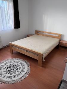 a bedroom with a bed in a room with a rug at Nedzarici sobe in Sarajevo +6 photos
