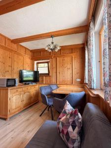 a living room with a couch and a tv at Ferienwohnung Martin in Zellberg