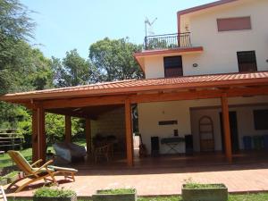 a house with a large deck with a roof at La Favola Verde in Roccadaspide