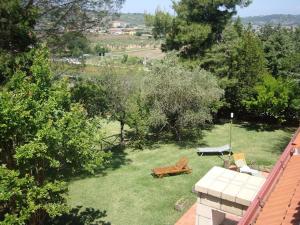 an aerial view of a garden with a bench and tables at La Favola Verde in Roccadaspide +12 photos
