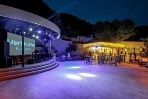 a patio with tables and chairs at night at Hotel Meri All inclusive in Oludeniz +110 photos