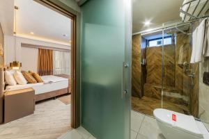 a bathroom with a glass shower and a bed at Ayramin Deluxe Hotel - Anex in Istanbul +79 photos