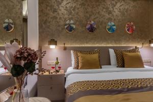 a bedroom with a king sized bed with yellow pillows at Ayramin Deluxe Hotel - Anex in Istanbul