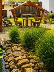 a garden with a table and a gazebo at Mátrai pincés udvar in Mátramindszent
