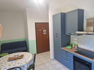 a small kitchen with a table and a dining room at Appartamenti Don Guglie' in Cetraro