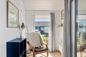 a room with a chair and a desk and a window at FY222-Otterup-Klovervaenget-13 in Otterup