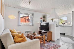 a living room with a couch and a tv at FY222-Otterup-Klovervaenget-13 in Otterup