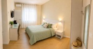 a bedroom with a bed and a television in a room at IL CENTRO rooms in Cerignola