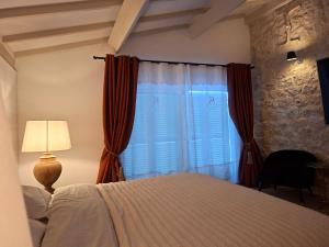 a bedroom with a bed and a window with red curtains at Casa Oksana in Castelnau-de-Montratier +36 photos