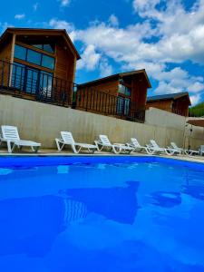 a house with chairs and a swimming pool at Sioni Hillside Cottages in Sioni