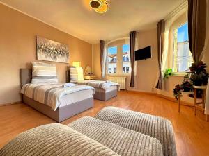 a living room with two beds and a couch at Pension J&M in Meißen