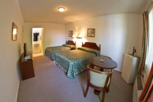 a hotel room with two beds and a table at Family Inn in San Rafael +44 photos