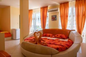 a bedroom with a bed with a snake on it at Boutique Guest House 'Sofia' in Nesebar