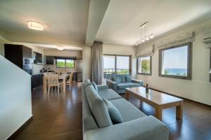 a living room with a couch and a table at Villa Anna by Villa Select in Skala