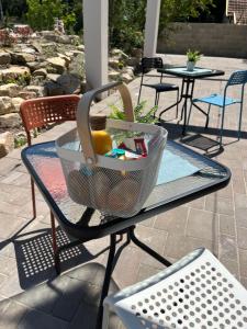 a table with a basket on top of it at Pensili Apartmanház Balatonfüred in Balatonfüred