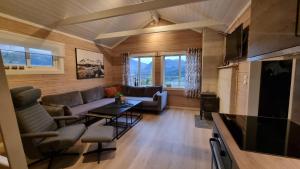 a living room with a couch and a table at Brudevoll Gard in Ørsta