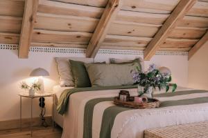 a bedroom with a bed with a wooden ceiling at Tajna Bazia in Nidzica