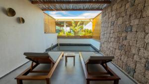a pool room with two tables and two chairs at Leone Cunda Edition Otel in Ayvalık