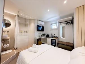 a white bedroom with a shower and a bed at Sky Garden - luxury suite in Monopoli