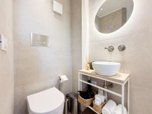 a bathroom with a toilet and a sink and a mirror at Sky Garden - luxury suite in Monopoli