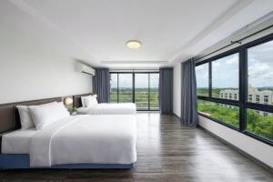 a bedroom with two beds and large windows at The Grand Palm Villa in Ban Bang Phrao +13 photos